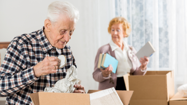 an elderly couple selecting items for packing 