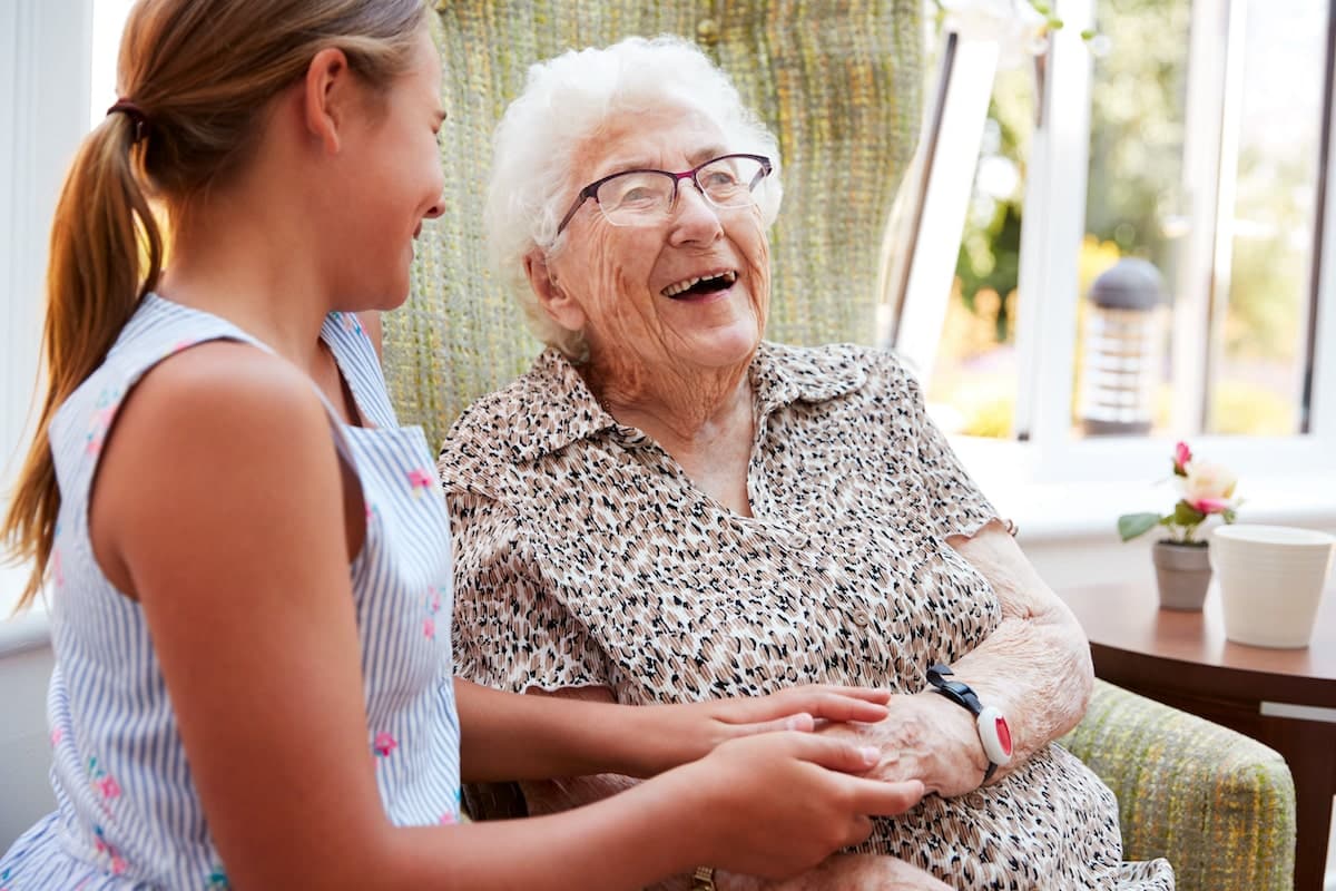 Older woman joyfully having a conversation with a younger girl