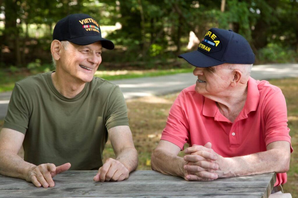 two veterans in senior living sitting at table